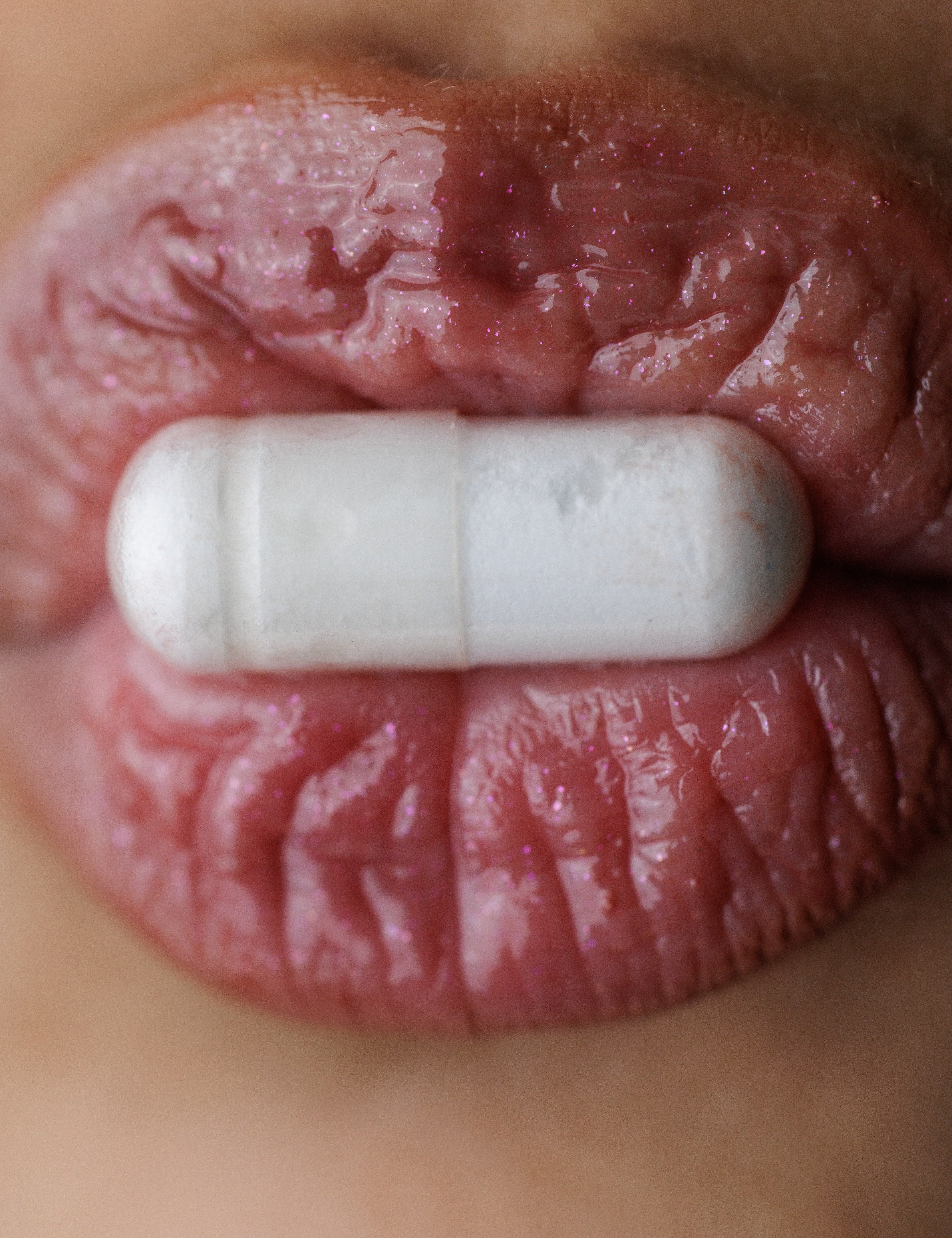 Close up of mouth with a pill
