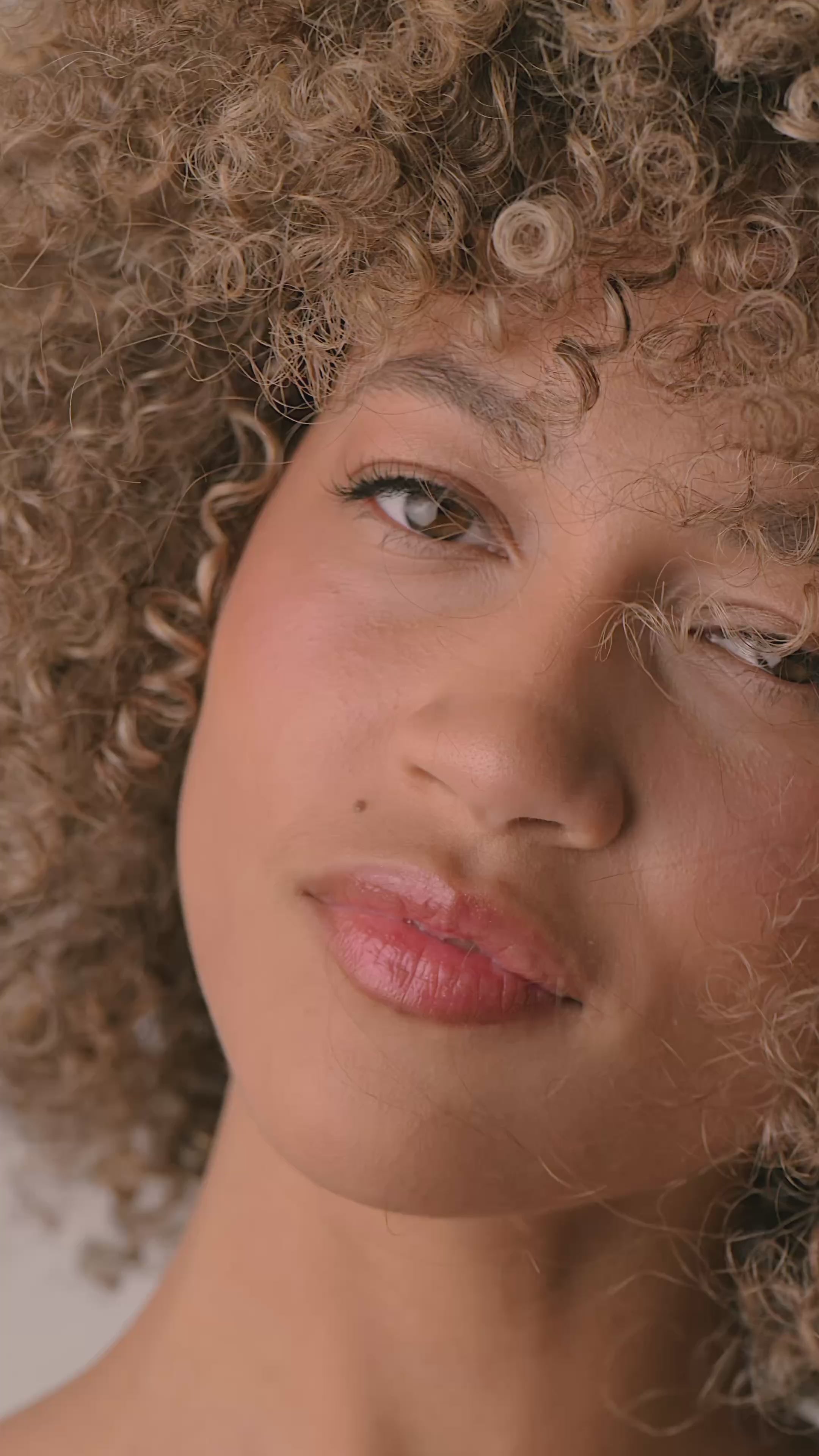 video of woman in slow motion with closeup of skin and hair